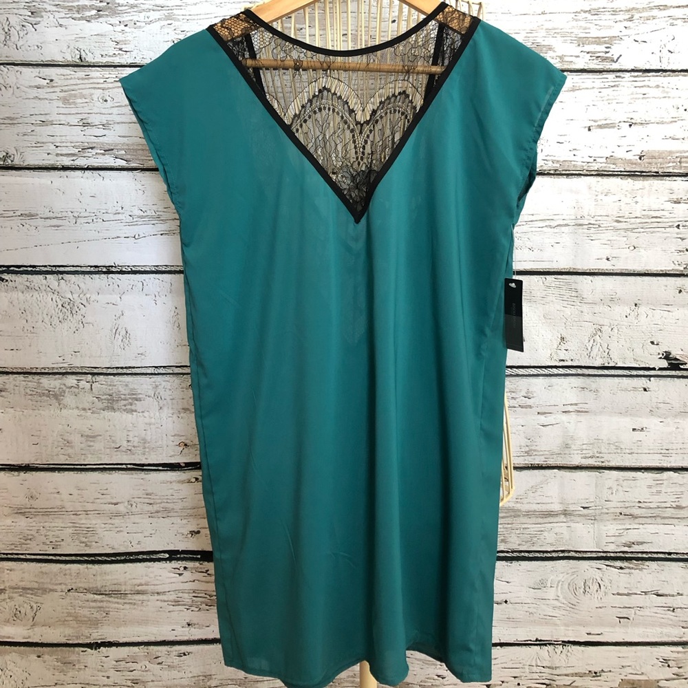 V neck top with black lace detail. Deep V in back